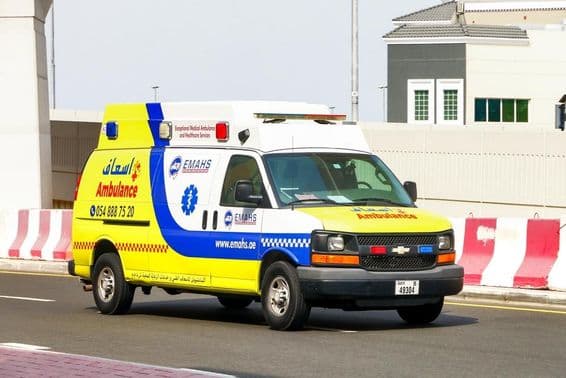 Chevrolet Express ambulance on a city street.