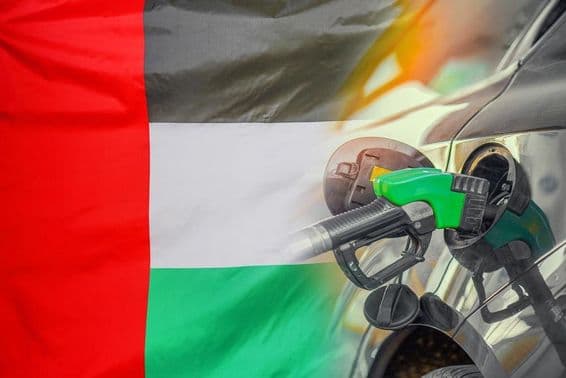 Car with fuel nozzle against United Arab Emirates flag background.