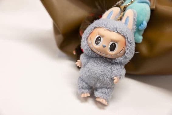 View of the famous Popmart Labubu on a woman's bag.