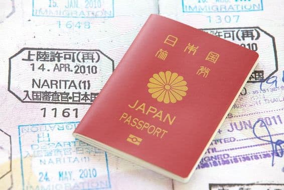 Japanese passport with stamps in the background.