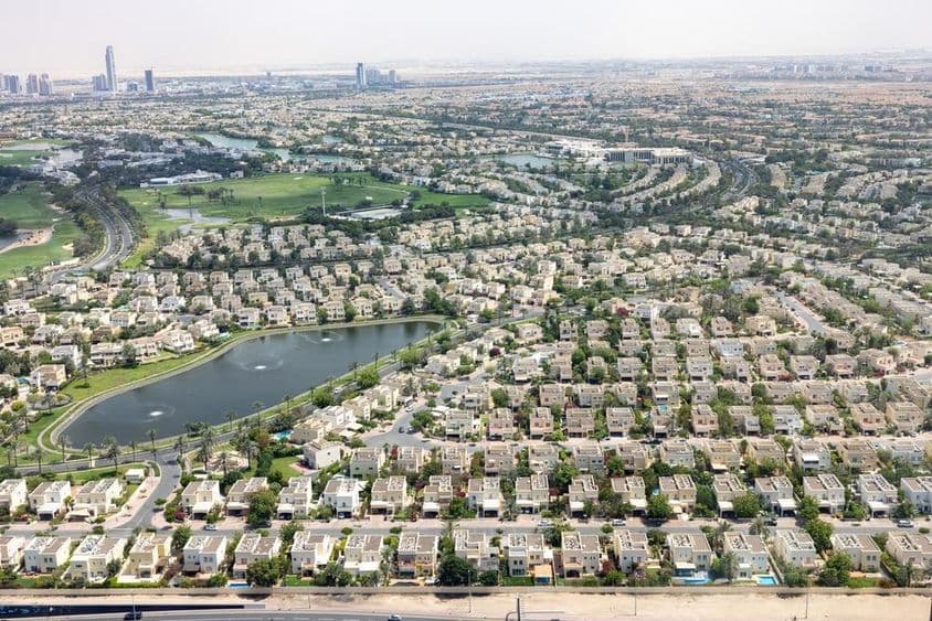 Emirates Hills Dubai with community houses, lake, and greenery.