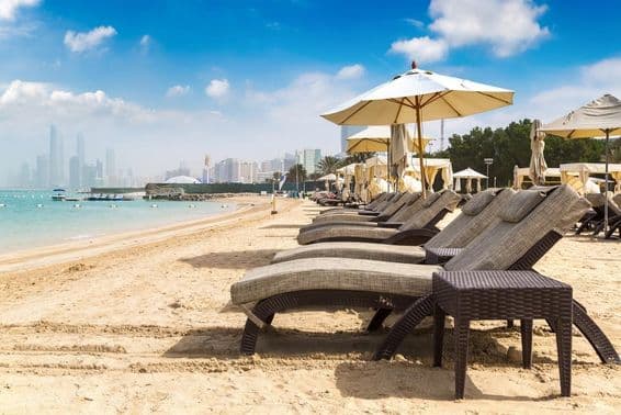 Sunbeds and parasols on the beach in Abu Dhabi.