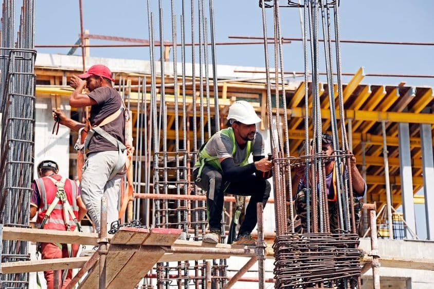 Dubai, United Arab Emirates, men working at a construction site.