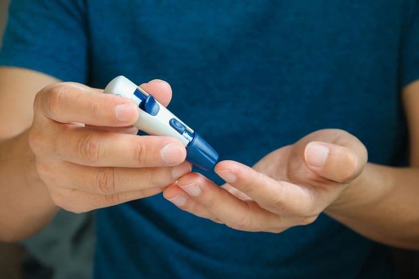 Diabetes management and hyperglycemia check with blood glucose monitor.