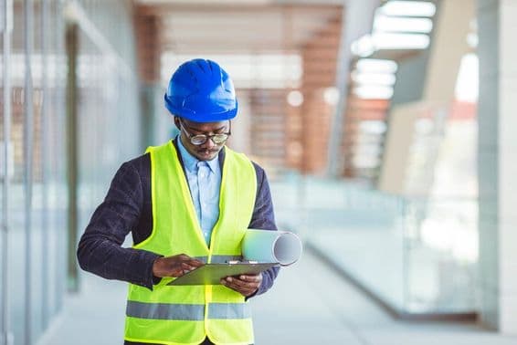 Young civil engineer analyzing paper statistics.