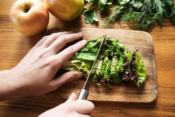 female hands preparing a salad for dinner.