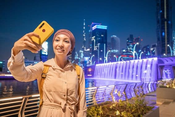 A female blogger taking a selfie in downtown Dubai.