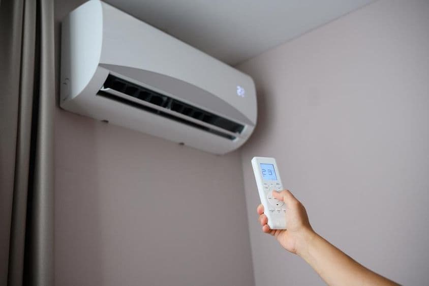 Person sets air conditioner to 22 degrees Celsius.