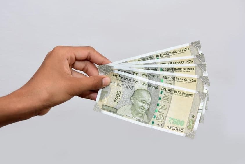 A person holds Indian new currency 500 rupee banknotes.