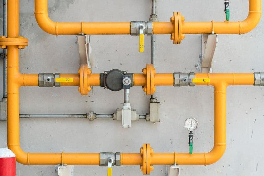 Gas pipe on the wall in yellow color.