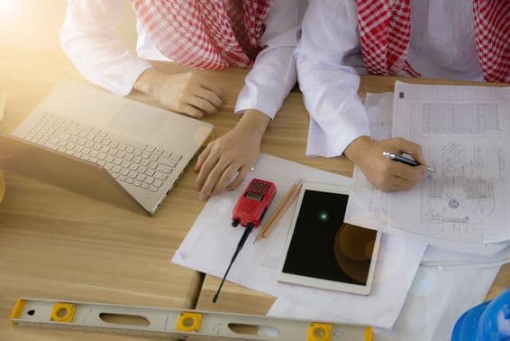 An Arab engineer working at a desk.