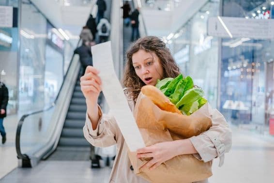 A shocked woman in a supermarket at a shopping mall.