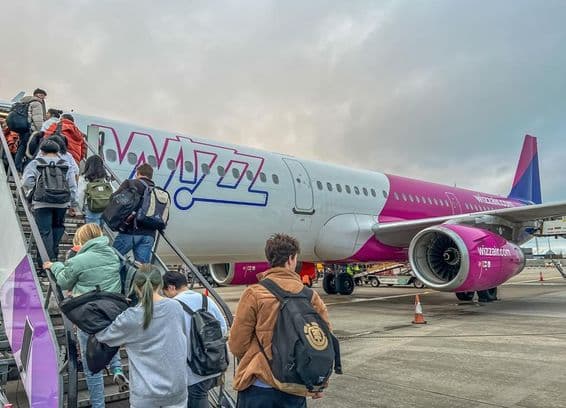 Backpackers boarding a Wizz Air airline plane