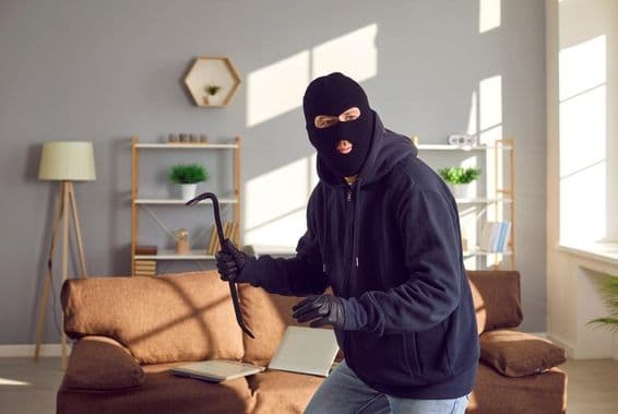 Thief breaking into someone's home.