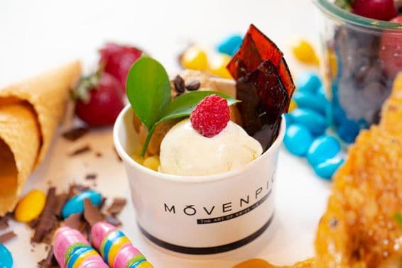 Movenpick vanilla ice cream cup with sprinkles.