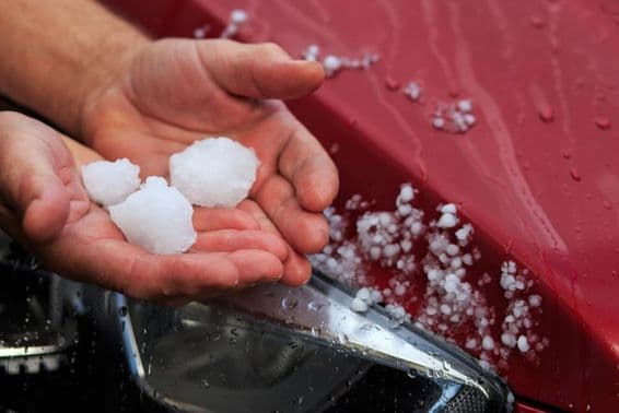 A person holding hail in their hand.
