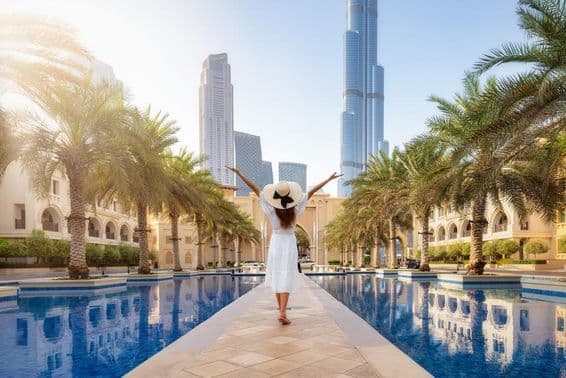 A female tourist walking along the streets of Dubai, UAE during her vacation.