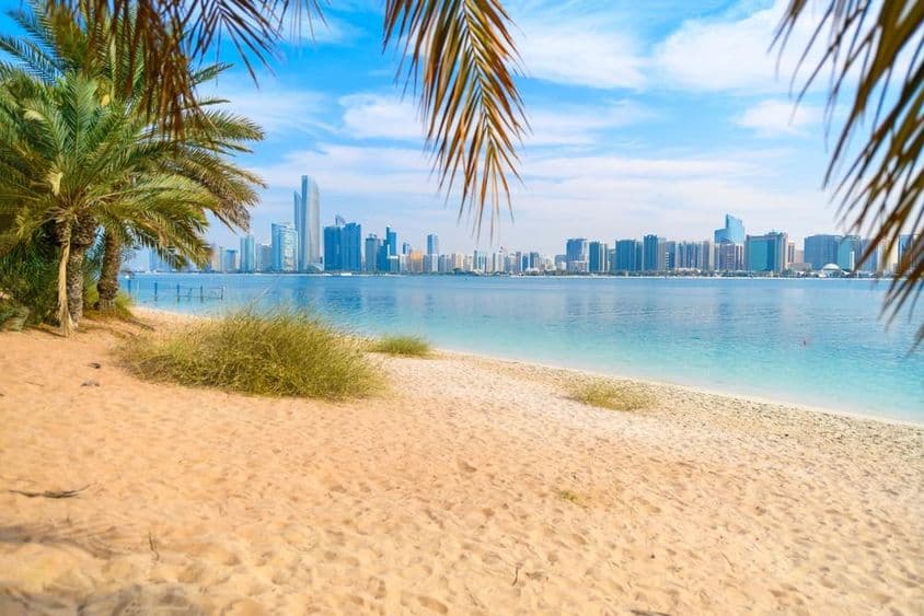 View from the sandy beach of Marina Mall Island to the waterfront promenade.