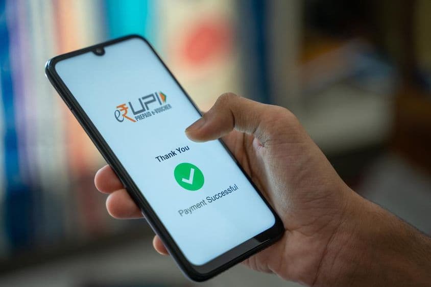 Transferring money using e-RUPI, a QR code or SMS-string based e-voucher.