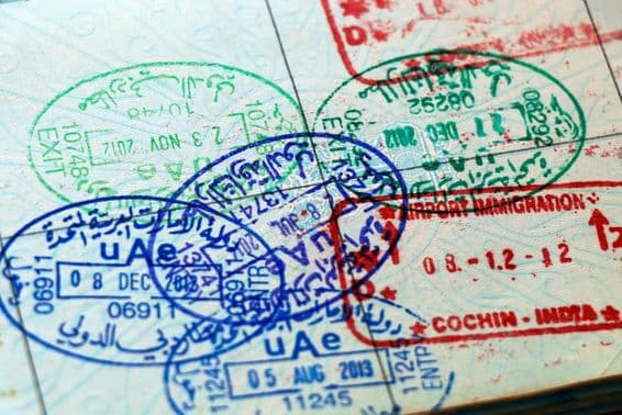 Official UAE and Indian stamps on a passport page.