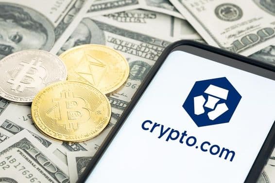 Crypto.com logo, dollar bills, Bitcoin and Ethereum coins visible.