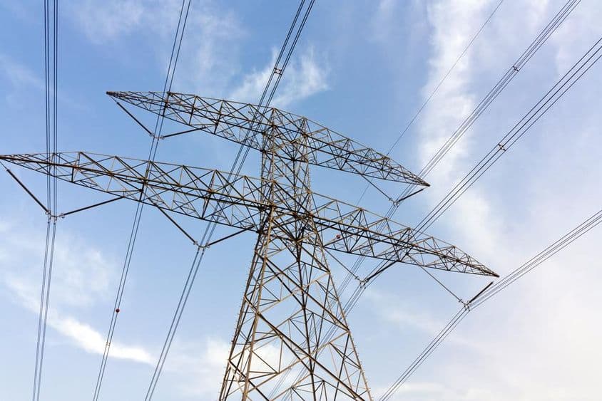 High-voltage transmission lines and clouds.