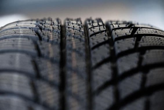 Tire tread highlighting deep grooves and intricate patterns.