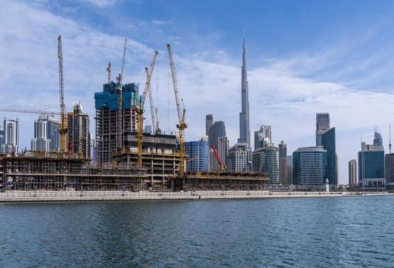 Cranes constructing new apartments in the Business Bay area of Dubai.
