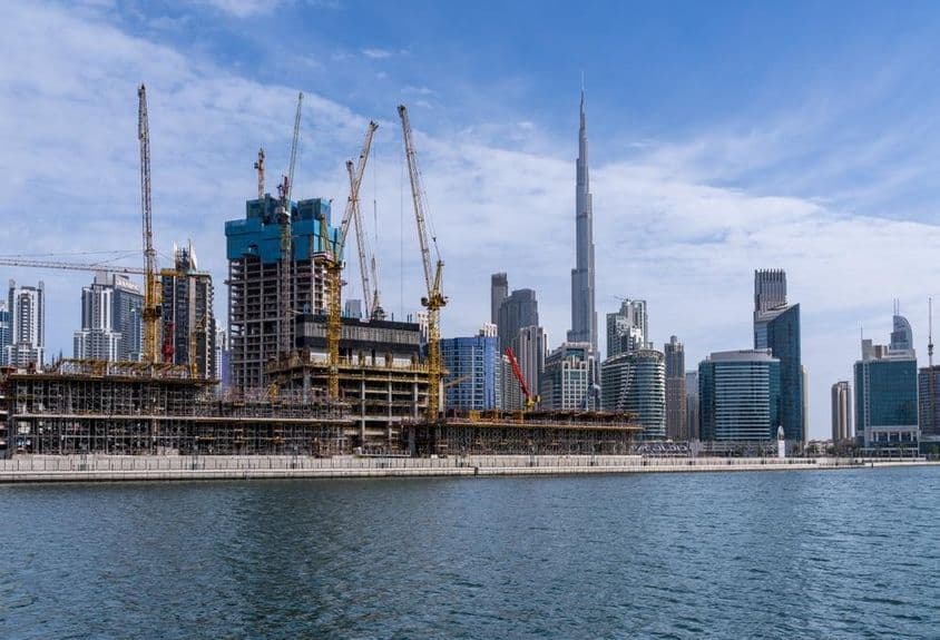 Cranes constructing new apartments in the Business Bay area of Dubai.