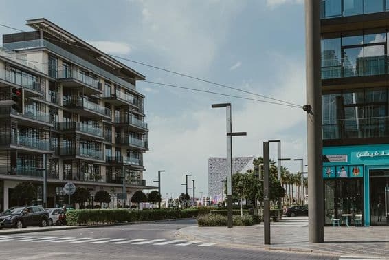 The street view of Al Mustaqbal Street at Dubai City Walk with modern apartments.