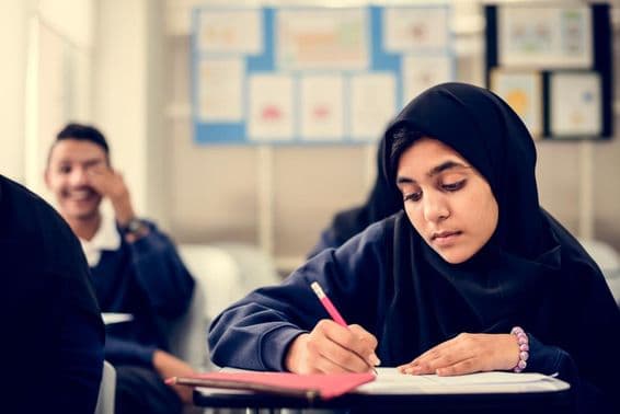 Muslim children studying in a classroom.