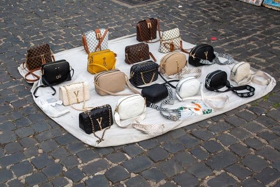 Counterfeit handbags and wallets for sale on the streets of Rome.