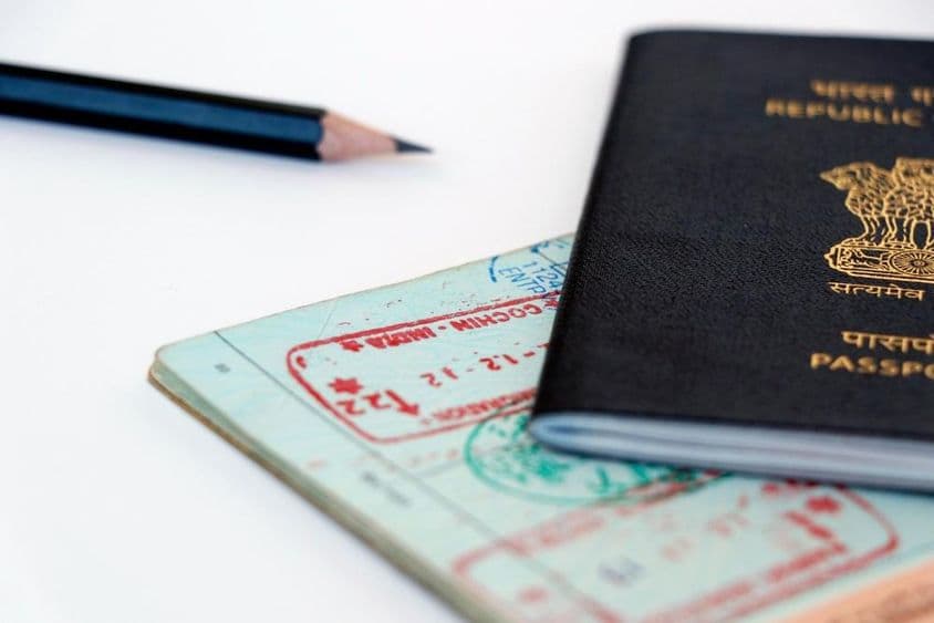 United Arab Emirates and Indian official stamps on a passport page, in Arabic and Hindi.