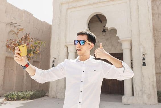 Man recording a video blog in the old Bur Dubai Creek district.