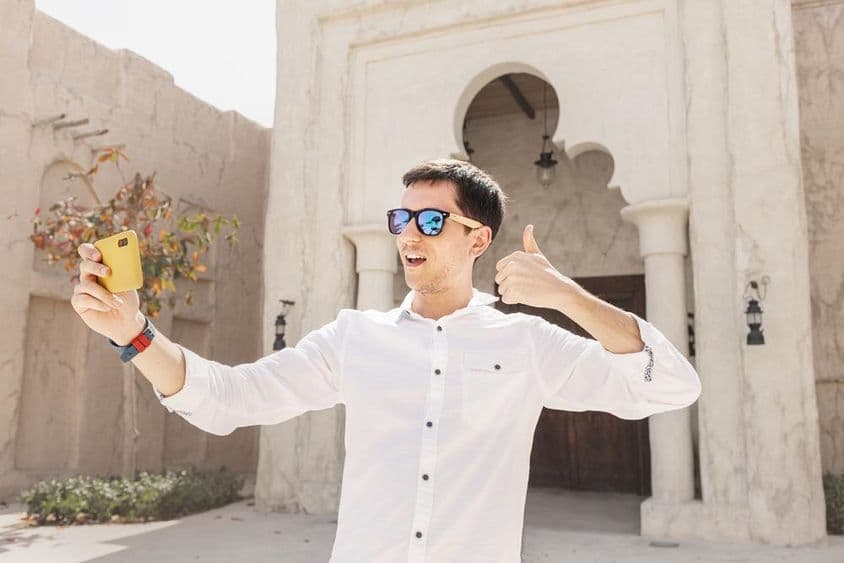 Man recording a video blog in the old Bur Dubai Creek district.