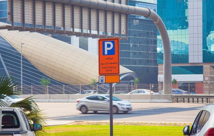 Paid parking sign on a Dubai street.