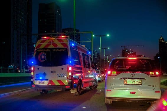 An ambulance speeds past another vehicle in Abu Dhabi.