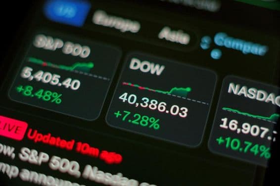 Stock rally showing green charts on screen.