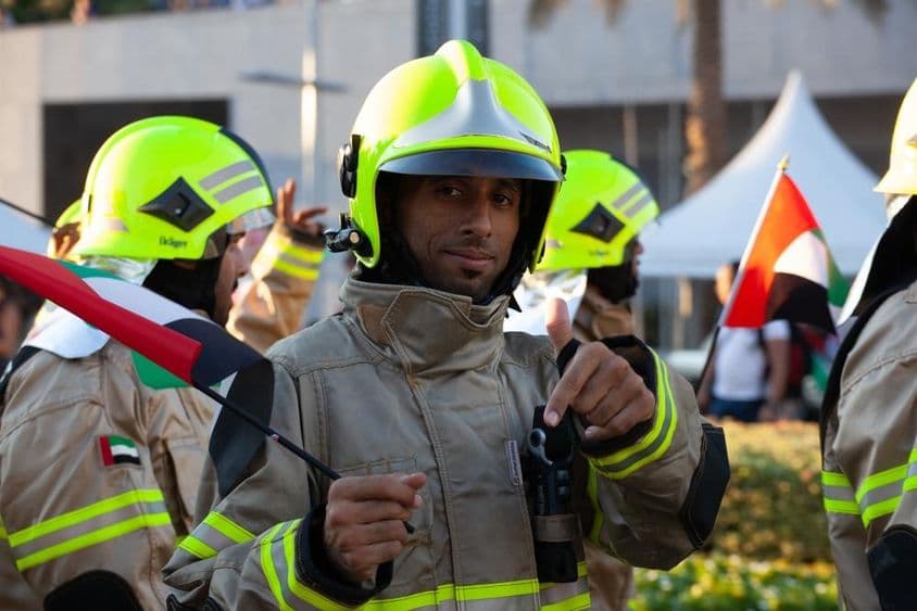 UAE firefighters walking with the Emirates flag on the occasion of the national holiday.