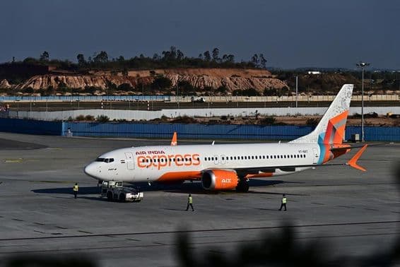 Air India Express aircraft parked on the runway.