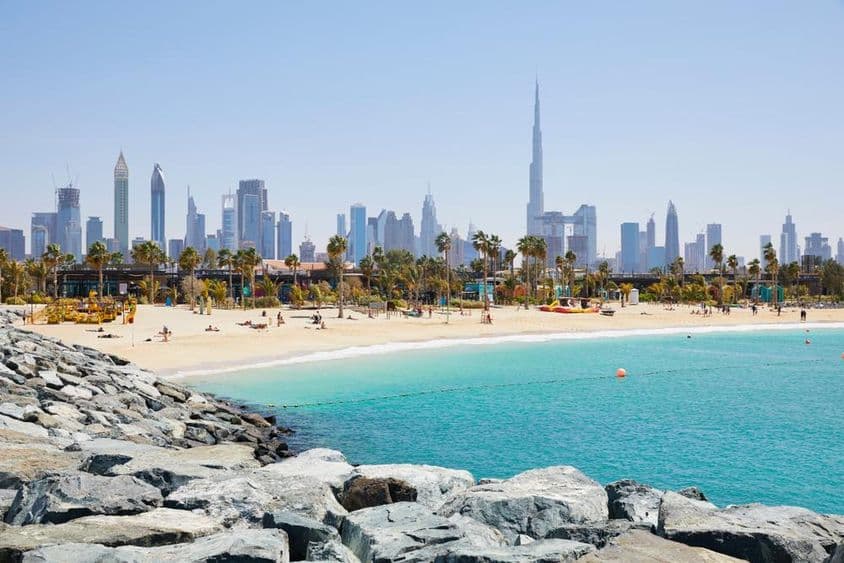 La Mer beach with a backdrop of the Dubai skyline, United Arab Emirates.