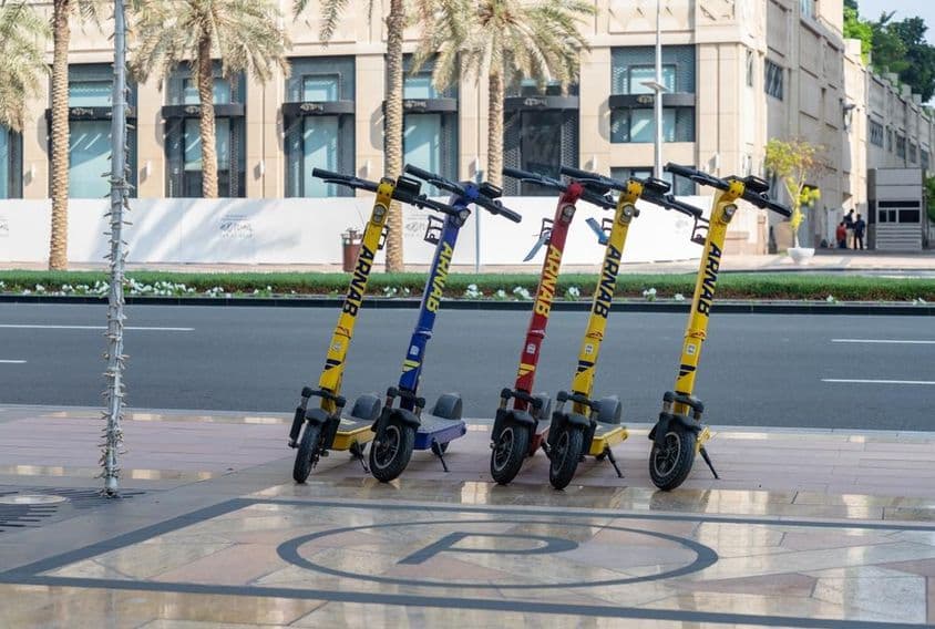 Picture of orange electric scooters in Dubai.