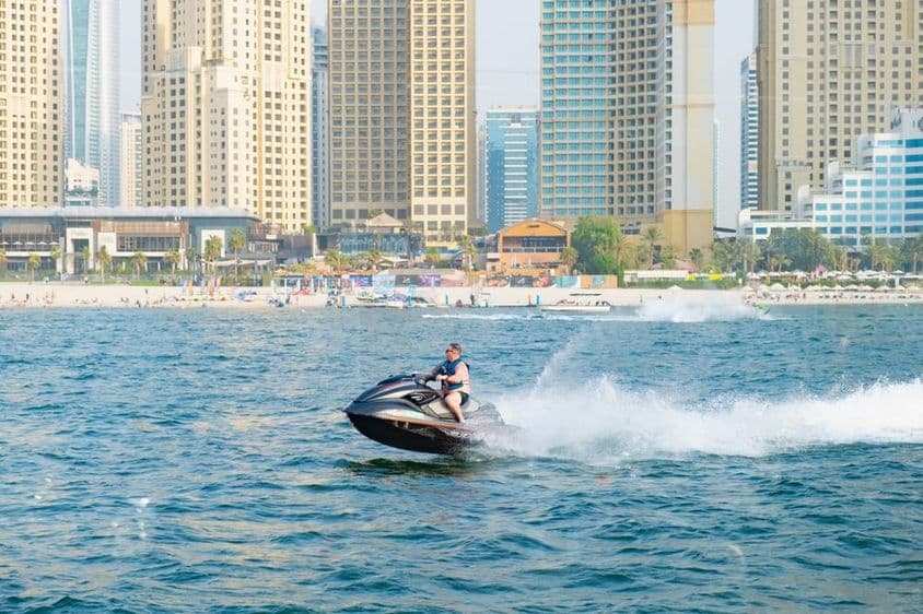 Man jet-skiing in Dubai Marina Bay.