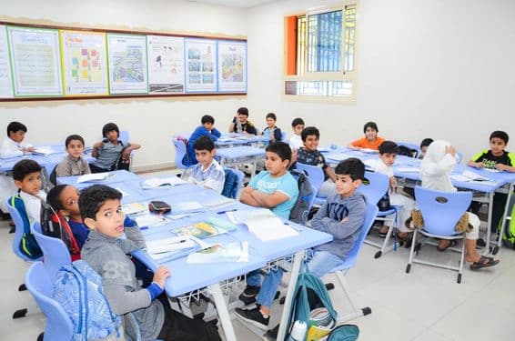 A classroom with a group of Arab students learning.