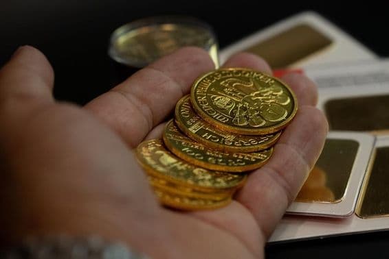 Holding real Austrian gold coins in hand.