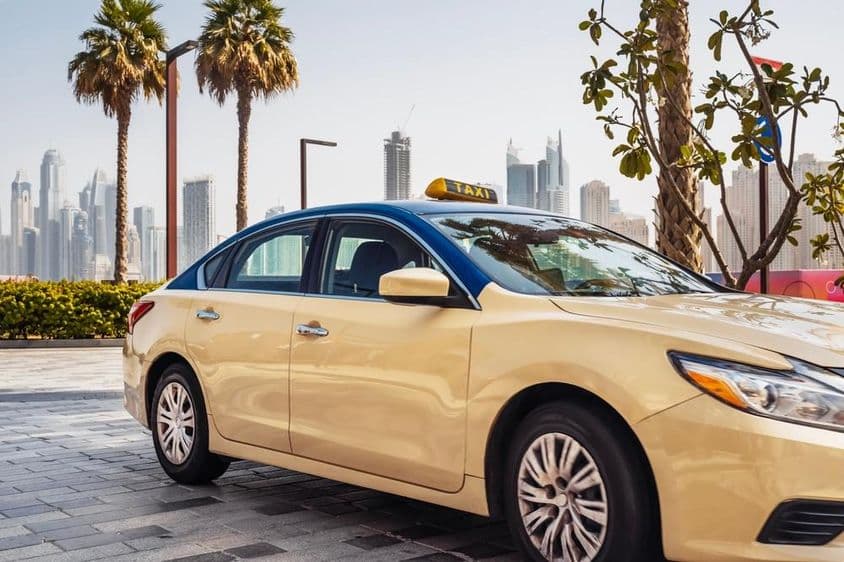 Taxi driving down a street in Dubai.