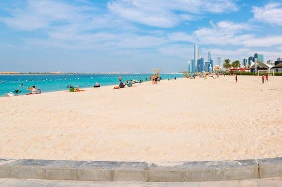 The wide, sandy Corniche beach on the Arabian Gulf.