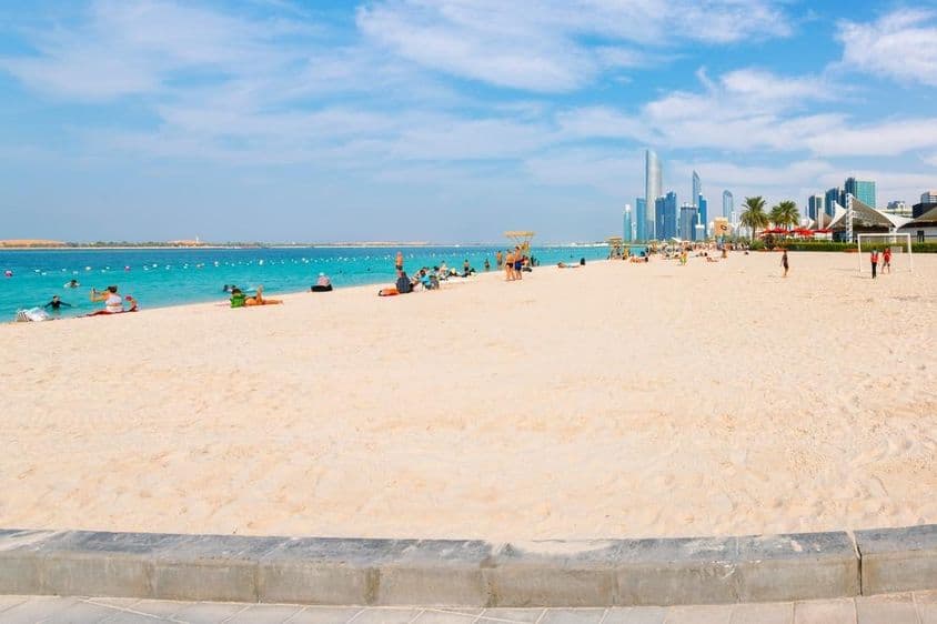 The wide, sandy Corniche beach on the Arabian Gulf.