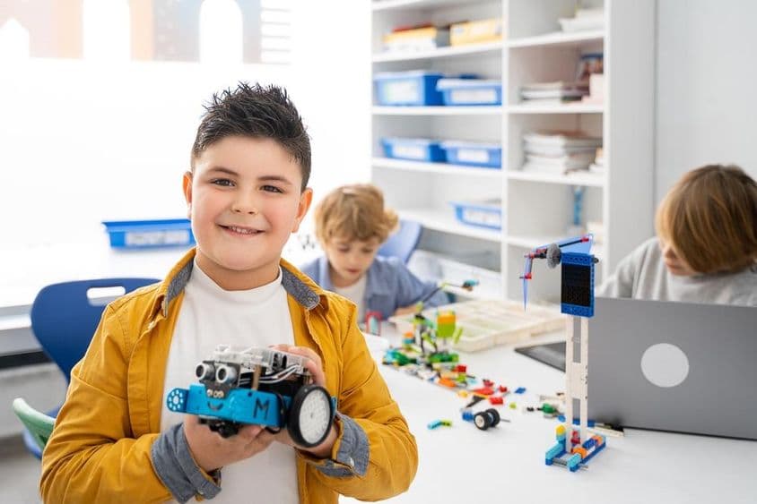 Children building and coding a robot.
