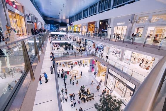 Interior view of Dubai Mall with various shops and visitors.